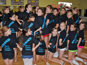 Large group of dancers smiling at camera