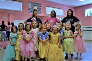 Young dancers in princess costumes pose with three teachers