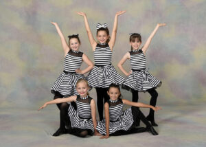 A small group of young dancers wearing jazz shoes